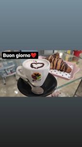 a cup of coffee and a plate of food at Cascina Tesoriera in Santhià
