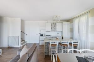 a kitchen and living room with a table and chairs at Borgo Stropea by Whale Homes in Soiano del Lago