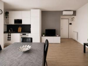 a kitchen and dining room with a table and chairs at Civico 8 in Bollate