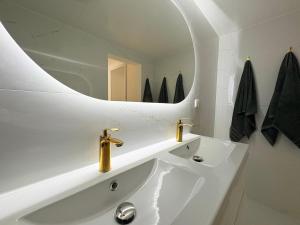 a white bathroom with a sink and a mirror at La Jungle du Vernet, Ambiance Tropicale in Le Vernet +23 photos