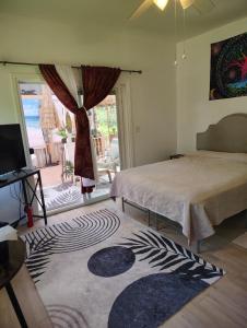 a bedroom with a bed and a view of a patio at Hoomaikai Blessings in Keaau +53 photos