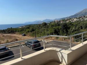 a car parked in a parking lot next to the ocean at Ninas Seaview Apartment in Bar +5 photos