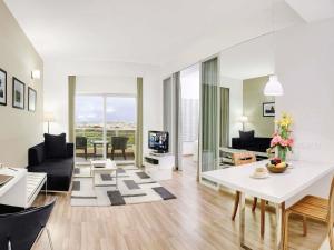 a living room with a white table and a couch at Grand Mercure Bangalore - An Accor Brand in Bangalore