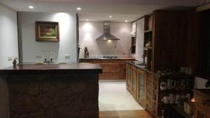 a large kitchen with a large island in the middle at Un Espacio de Buscadores in Ingeniero Maschwitz +41 photos