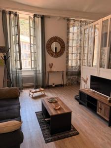 a living room with a couch and a table at Le Charme d'Anduze in Anduze