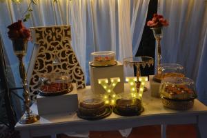 a table with candles and cakes and vases on it at Finca Hotel Campestre Salitre Villeta in Villeta