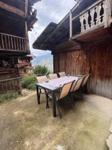 a table and chairs sitting on a patio at Appartement Grande Dixence - Hérémence in Hérémence