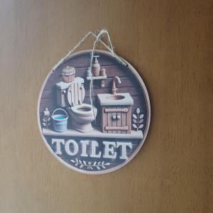 a toilet sign hanging on a wall at Bnb Bouveret in Port-Valais
