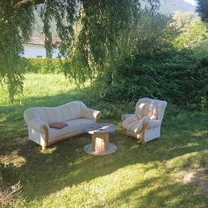 two couches and a coffee table in a yard at Bnb Bouveret in Port-Valais