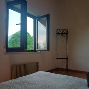 a bedroom with two windows and a bed in it at Bnb Bouveret in Port-Valais