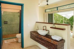 a bathroom with a sink and a toilet at Casa Mia El Cuyo Eco Beach Boutique Hotel Sin Aire Acondicionado in El Cuyo +169 photos