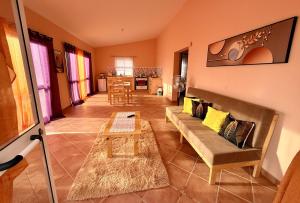 a living room with a couch and a table at Ocean Pearl Beach House in Morro