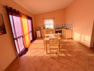 a kitchen with a table and chairs in a room at Ocean Pearl Beach House in Morro