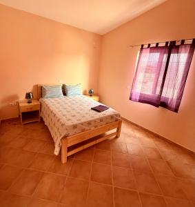 a bedroom with a bed and a window at Ocean Pearl Beach House in Morro