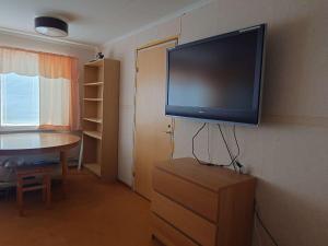 a flat screen tv on the corner of a room at Höghedens camping in Älvsbyn