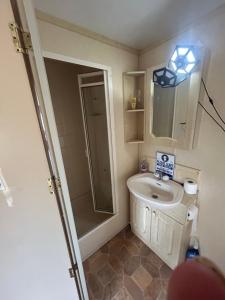 a small bathroom with a sink and a shower at Ready Pitched Tent stay Bring your own bedding in Trefnant +15 photos