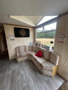 a living room with a couch and a window at Ready Pitched Tent stay Bring your own bedding in Trefnant