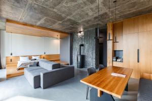 a living room with a couch and a table at Шпиці boutique hotel & SPA in Yablunytsya