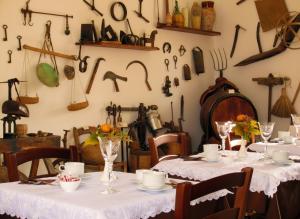 a table with white tablecloths and utensils on the wall at Candalù - Villa Giardinata in Valderice