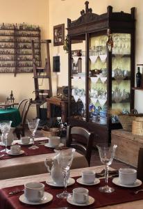 a dining room with a table with plates and glasses at Candalù - Villa Giardinata in Valderice