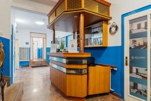 a room with a counter and a blue wall at Hotel Hanseat Hamburg - Free Parking in Hamburg