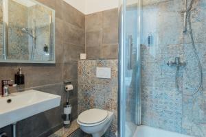 a bathroom with a shower and a toilet and a sink at Hotel Hanseat Hamburg - Free Parking in Hamburg +54 photos