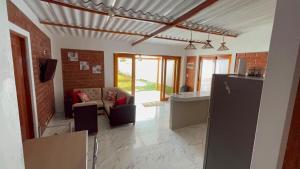 a living room with a couch and a kitchen at Villa Arcoíris in Paita +9 photos