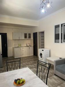 a kitchen and living room with a table and chairs at At home in Yerevan