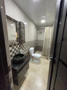 a bathroom with a toilet and a sink at At home in Yerevan
