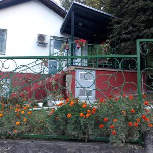 a balcony with orange flowers on a building at Apartman MiG in Berkovac +9 photos