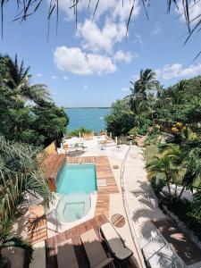 an outdoor swimming pool with a view of the ocean at BOA BOA Bacalar in Bacalar