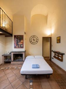 a large room with a bed and a fireplace at Living Adua Centro in Tortona