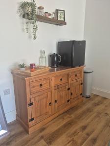 a television on top of a wooden cabinet in a room at Highlands in Pinchbeck