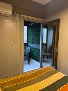 a bedroom with a bed and a sliding glass door at Danella in San Miguel de Tucumán