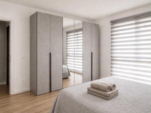 a bedroom with a bed with a large mirror at Civico 8 in Bollate