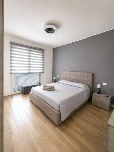 a bedroom with a large bed and a window at Civico 8 in Bollate +2 photos
