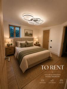 a bedroom with a large bed with a ceiling fan at Blackberry Barn in Baltonsborough