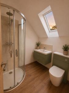 a bathroom with a shower and a toilet and a sink at Blackberry Barn in Baltonsborough +4 photos