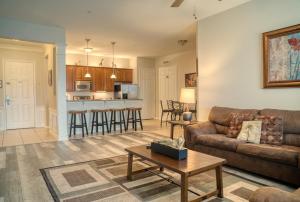 a living room with a couch and a table at Vista Cay Luxury Loft in Orlando