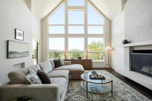 a living room with a couch and a large window at Sunset Ridge Ranch - Pool Outdoor Kitchen & Views in Dripping Springs