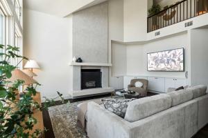a living room with a couch and a fireplace at Sunset Ridge Ranch - Pool Outdoor Kitchen & Views in Dripping Springs