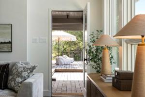 a living room with a door leading to a patio at Sunset Ridge Ranch - Pool Outdoor Kitchen & Views in Dripping Springs +73 photos