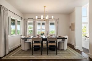 a dining room with a black table and chairs at Sunset Ridge Ranch - Pool Outdoor Kitchen & Views in Dripping Springs