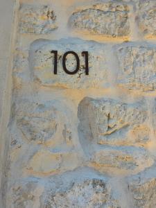 a stone wall with the number written on it at Pietra Museum Suites Sirolo in Sirolo