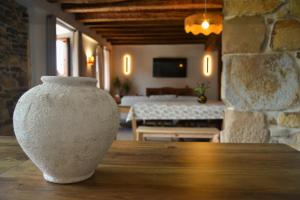 a white vase sitting on a table in a room at AIXPE apartamentos boutique in Osma