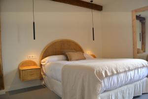 a bedroom with a large bed and a night stand at AIXPE apartamentos boutique in Osma