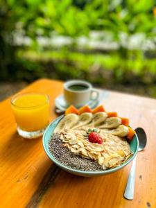 a plate of food on a table with a cup of coffee at Karandi Hostel Uvita in Uvita
