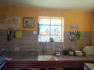 a kitchen with a sink and a window at Casa de campo y Chalet las Morenas in Sicuani +41 photos