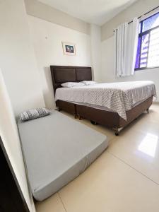 a bedroom with two beds and a mattress at Ocean Tower in São Luís +17 photos
