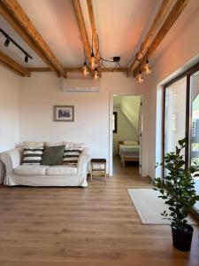 a living room with a couch and a table at Dana apartment with Garden near Tara National Park in Bajina Bašta